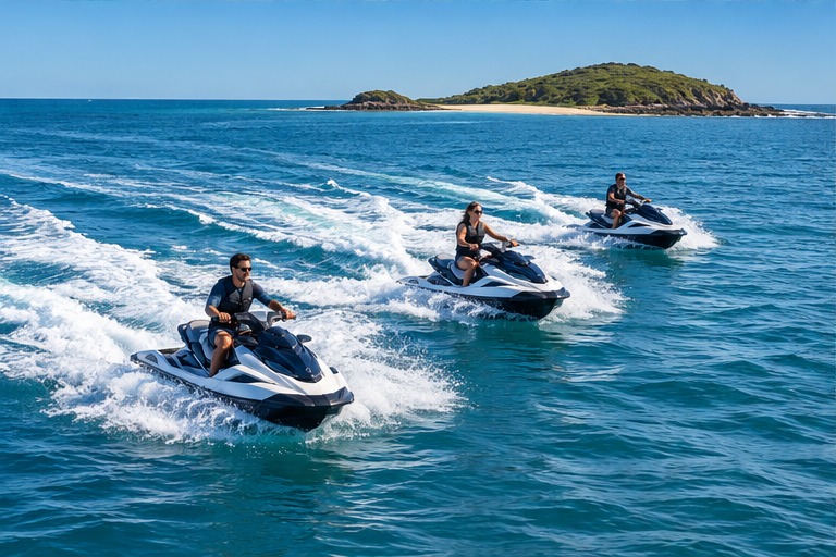 A small group of jet ski riders on open blue water